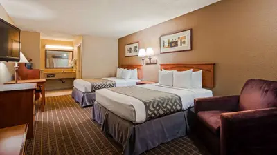 a hotel room with two beds and a couch at Cajon Pass Inn in Cajon Junction