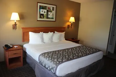a large bed in a hotel room with two lamps at Cajon Pass Inn in Cajon Junction