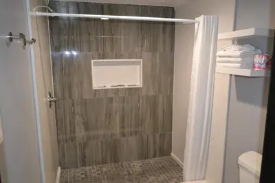 a shower in a bathroom with a shower curtain at Bell Gardens Inn Los Angeles - Bell Gardens in Bell Gardens