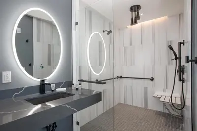 a bathroom with a sink and a mirror at The Glenmark, Glendale, a Tribute Portfolio Hotel in Glendale