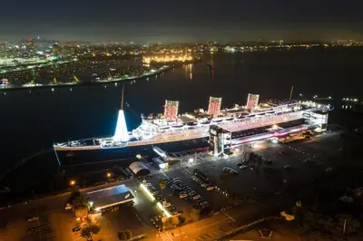 a large cruise ship in the water at night at Parkside Inn in Long Beach