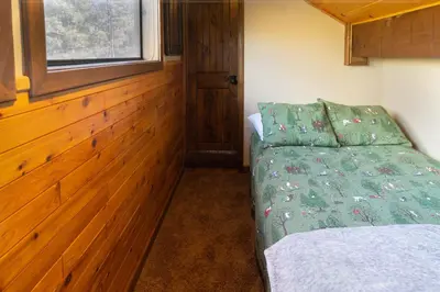 a small bedroom with a bed and a window at Luxury Lodge-1888 by Big Bear Vacations in Big Bear Lake