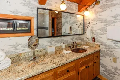a bathroom with a sink and a mirror at Woodland Log-1887 by Big Bear Vacations in Big Bear Lake