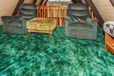 a living room with two chairs and a green carpet at Makin' Memories At Summit-1683 by Big Bear Vacations in Big Bear Lake