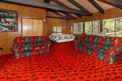 a living room with two chairs and a bed at Makin' Memories At Summit-1683 by Big Bear Vacations in Big Bear Lake