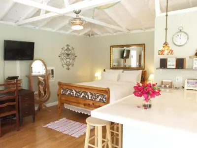 a bedroom with a bed and a kitchen with a counter at Culver City Escape with Pool, Near Disneyland Park! in Los Angeles