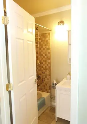 a bathroom with a shower and a tub and a sink at Culver City Escape with Pool, Near Disneyland Park! in Los Angeles