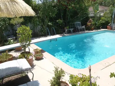 a large blue swimming pool in a yard at Culver City Escape with Pool, Near Disneyland Park! in Los Angeles