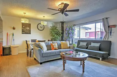 a living room with a couch and a table at 3 Mi to Dtwn Dining! Long Beach Condo with Balcony in Long Beach