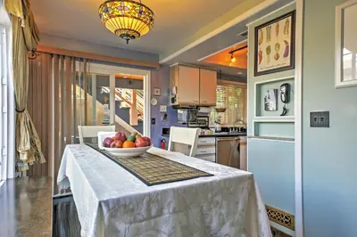 a kitchen with a table with a bowl of fruit on it at Unique Long Beach House with Patio, Grill and Balcony in Long Beach