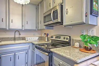 a kitchen with white cabinets and a stove top oven at Downtown Long Beach Condo - 1 Mi to Boardwalk! in Long Beach