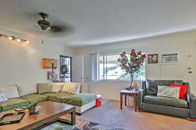 a living room with a couch and a table at Downtown Long Beach Condo - 1 Mi to Boardwalk! in Long Beach