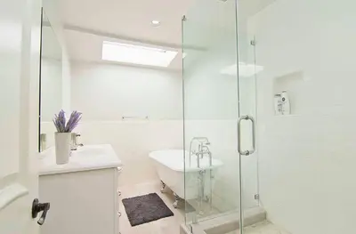 a bathroom with a sink and a glass shower at Hollywood's Garden Paradise at World Artists Living in Los Angeles