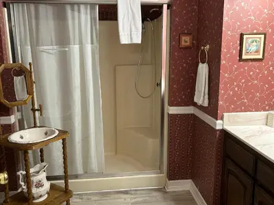 a bathroom with a shower and a sink at Arrowhead Lake Inn in Lake Arrowhead