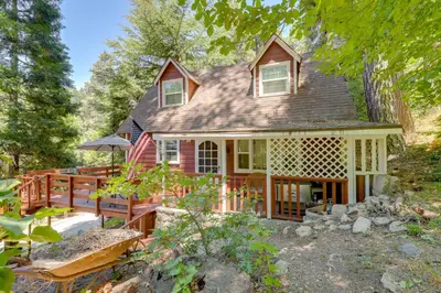 a house with a porch and a deck at Vintage Snow White Cottage about 2 Miles to Village! in Lake Arrowhead