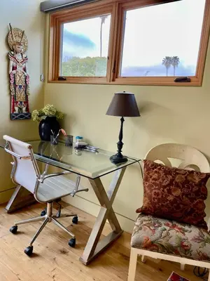 a glass desk with a lamp and a chair at Del Rey/Culver City Dream Oasis in Los Angeles