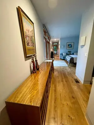 a living room with a wooden floor and a painting on the wall at Del Rey/Culver City Dream Oasis in Los Angeles