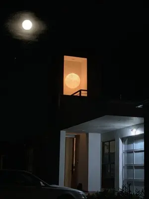 a moon seen through a window of a house at night at Del Rey/Culver City Dream Oasis in Los Angeles