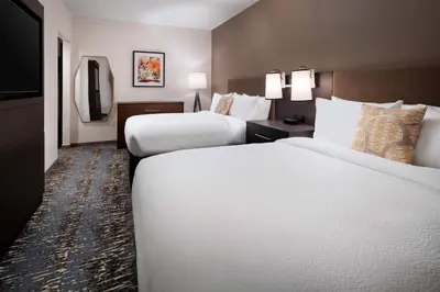 a hotel room with two beds and a television at Residence Inn Los Angeles Glendale in Glendale