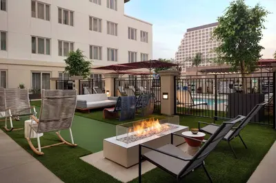 a patio with a fire pit and chairs and a building at Residence Inn Los Angeles Glendale in Glendale
