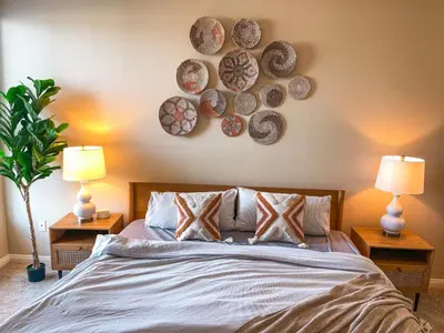 a bedroom with a bed with plates on the wall at Sunny 1BDR centrally located in Marina del Rey in Los Angeles