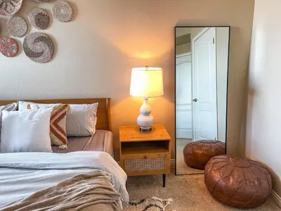 a bedroom with a bed and a lamp and a mirror at Sunny 1BDR centrally located in Marina del Rey in Los Angeles