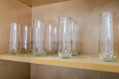 a row of clear glasses sitting on a shelf at Long Beach Duplex King Bed Pet Friendly Nurses Surgeon Business Travelers Near St Marys Medical Center & Downtown in Long Beach