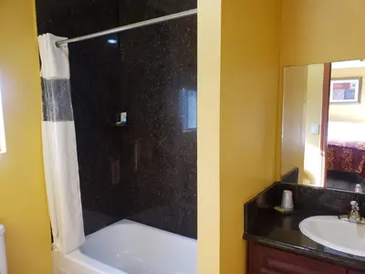 a bathroom with a shower and a sink at Providencia Motel in Burbank