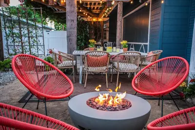 a patio with a fire pit with chairs and a table at Pet-Friendly Stay, Mins to Beach, Conv Ctr, Prkg LB B in Long Beach