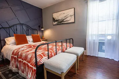 a bedroom with a bed with two chairs and a window at Pet-Friendly Stay, Mins to Beach, Conv Ctr, Prkg LB B in Long Beach