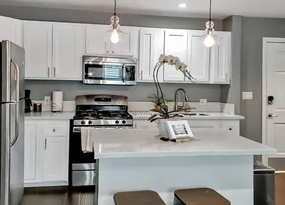a kitchen with white cabinets and a white counter top at Traveler's Pick Cozy, Near Beach & Dtwn,Prkg LB C in Long Beach