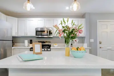 a kitchen with a counter with a vase of flowers on it at Traveler's Pick Cozy, Near Beach & Dtwn,Prkg LB C in Long Beach