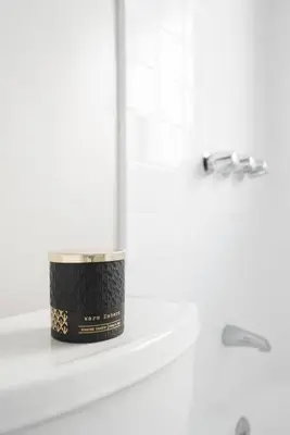 a candle sitting on a shelf in a bathroom at Historic Hm Mins to Beach, Convention Ctr Parking LB E in Long Beach