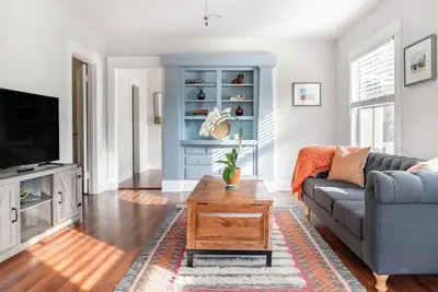 a living room with a couch and a coffee table at Historic Hm Mins to Beach, Convention Ctr Parking LB E in Long Beach