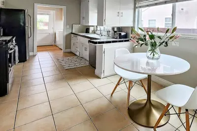 a kitchen with a table and a table and chairs at Stylish Hm Near Beach, Restaurants & Parking CC A in Los Angeles