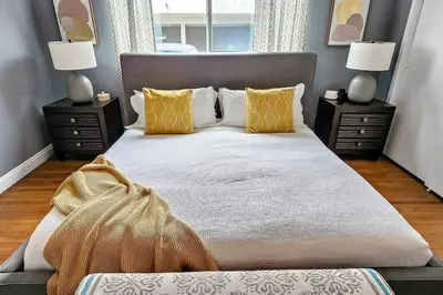 a bedroom with a large bed with yellow pillows at Stylish Hm Near Beach, Restaurants & Parking CC A in Los Angeles