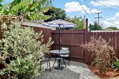 a patio with a table and an umbrella at Stylish Hm Near Beach, Restaurants & Parking CC A in Los Angeles