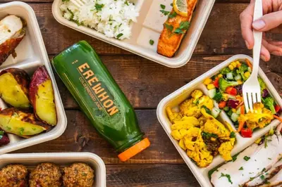 a wooden table with four plastic containers of food at Stylish Hm Near Beach, Restaurants & Parking CC A in Los Angeles