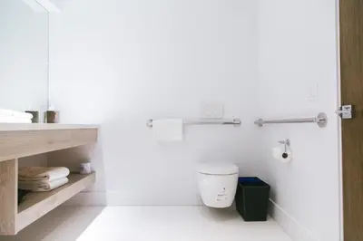 a white bathroom with a toilet and a sink at H2O Hermosa Beach Hotel in Hermosa Beach
