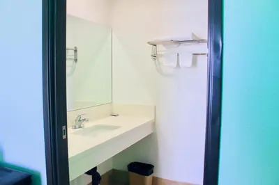 a bathroom with a sink and a mirror at Arlington Motel in Long Beach