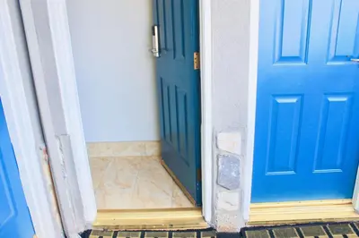 two blue doors are shown next to each other at Arlington Motel in Long Beach