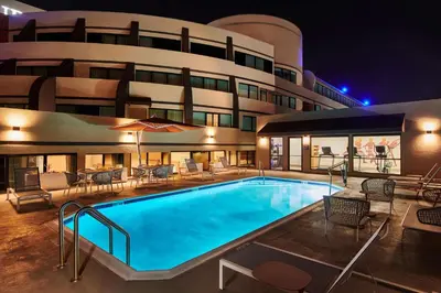 a pool in front of a hotel at night at Doubletree By Hilton Fullerton in Fullerton