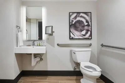 a bathroom with a white toilet and a sink at Doubletree By Hilton Fullerton in Fullerton