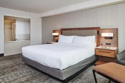 a hotel room with a large bed and a bathroom at Doubletree By Hilton Fullerton in Fullerton