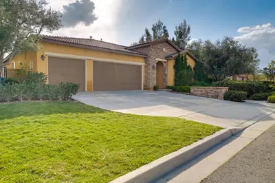a house with a driveway and a garage at Single-Story San Bernardino Home with Valley Views! in San Bernardino