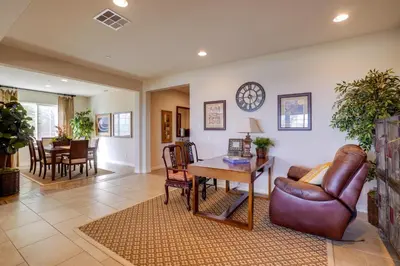 a living room with a couch and a table at Single-Story San Bernardino Home with Valley Views! in San Bernardino