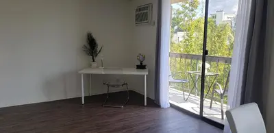 a white desk in a room with a balcony at Skyline Views 1-Bedroom with Balcony and Pool in Los Angeles