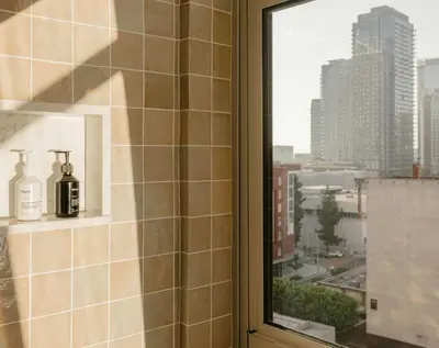 a bathroom window with a view of a city at The Hoxton, Downtown LA in Los Angeles