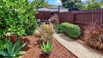 a backyard with a fence and a bench and plants at Top Pick Apartment Near Grocery Store Parking CCD in Culver City