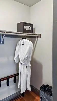 a white robe is hanging on a shelf with a toaster at Top Pick Apartment Near Grocery Store Parking CCD in Culver City